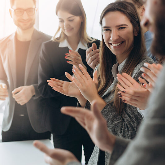 Great job! Successful business team is clapping their hands in modern workstation, celebrating the performance of new product